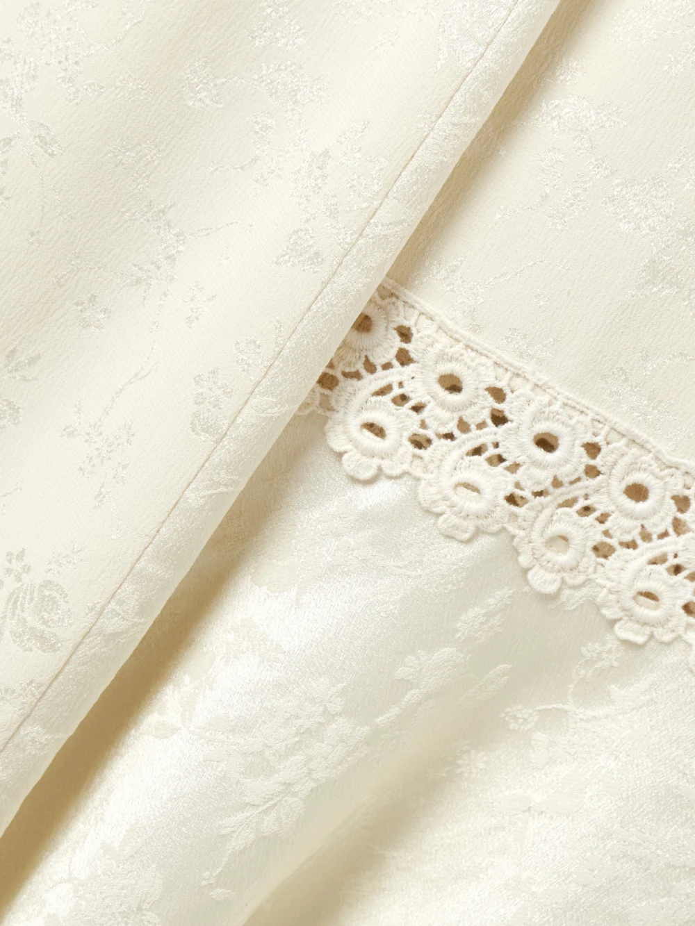 Close-up detail of the Maison Mayle Amparo Pleated Lace-trimmed Silk-satin Jacquard Midi Skirt
