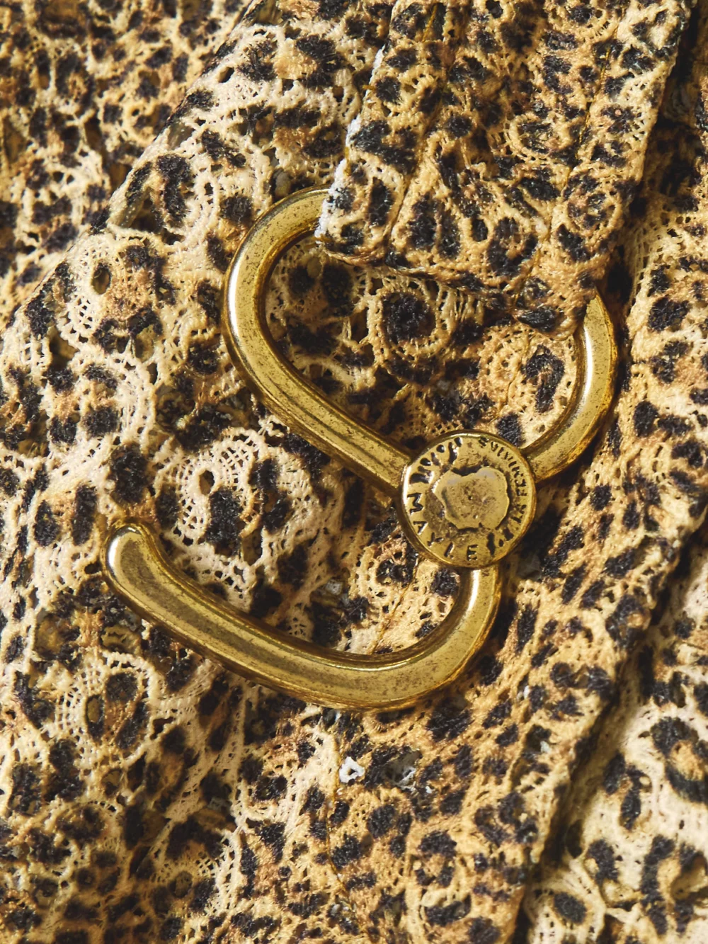 Close-up detail of the Maison Mayle Chappy Cropped Belted Leopard-print Woven Flared Pants