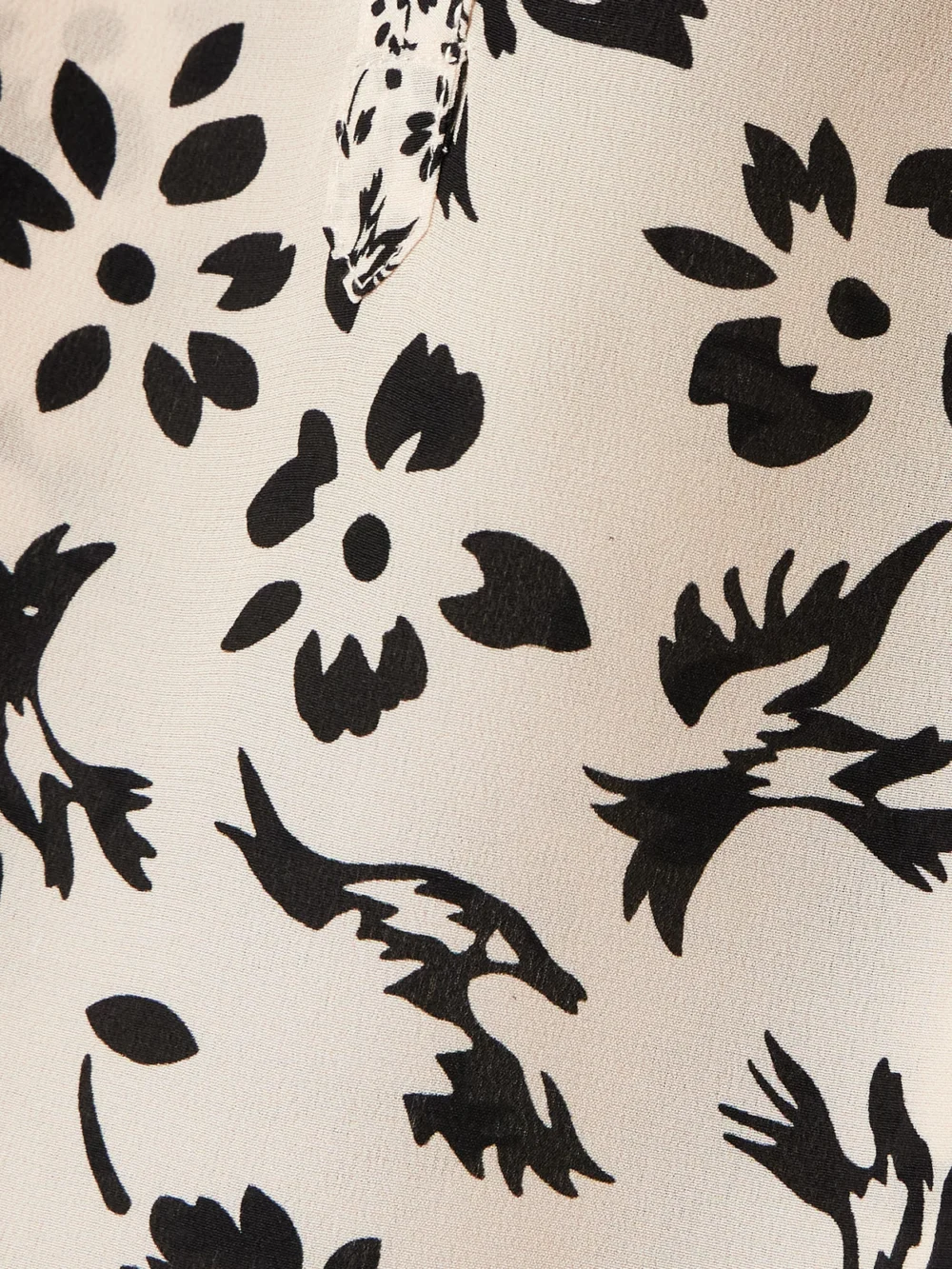Close-up detail of the Maison Mayle Majorelle Tie-detailed Ruffled Floral-print Silk Crepe De Chine Blouse