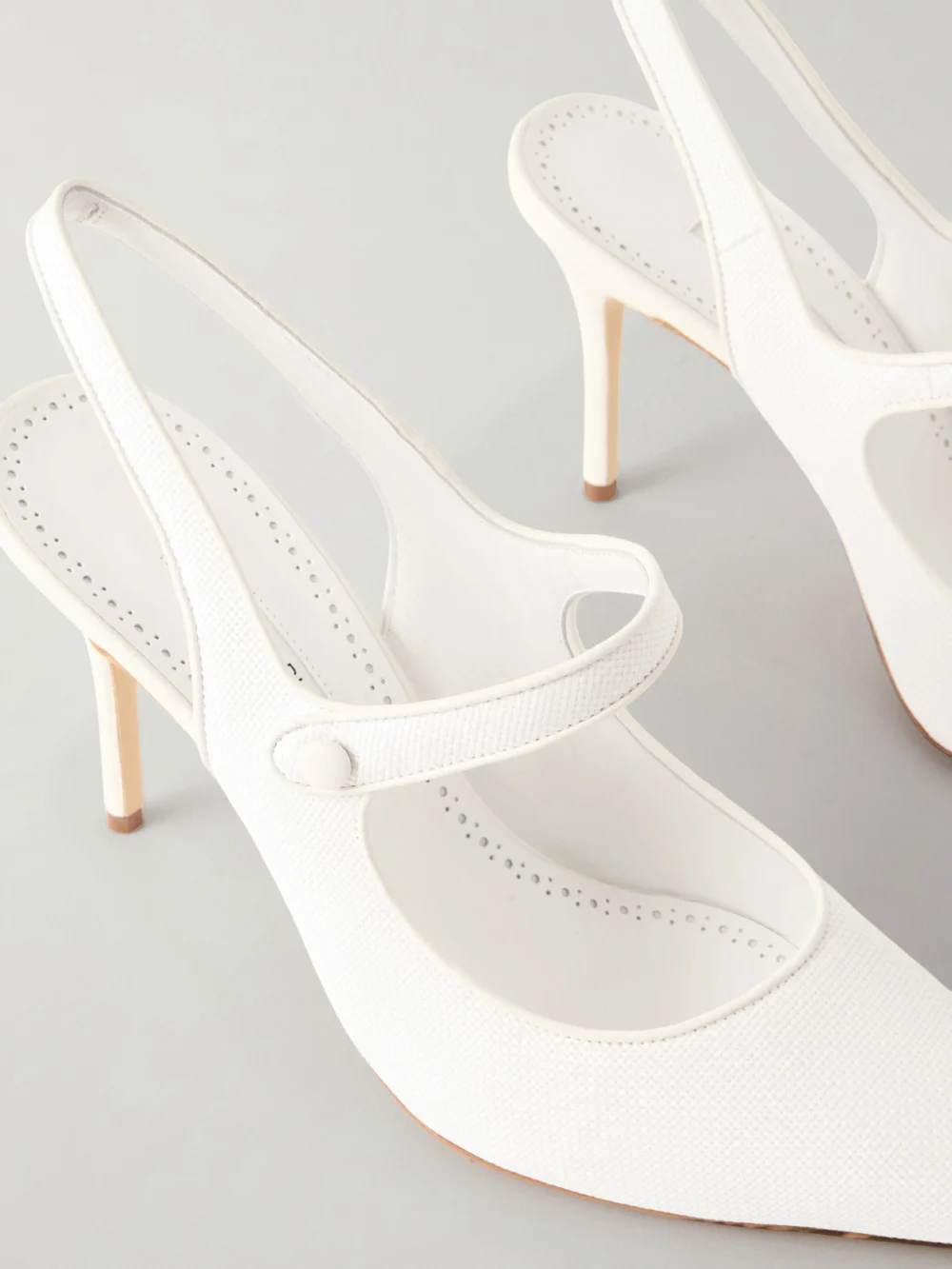 Close-up detail of the Manolo Blahnik Camparisli 90 Leather-trimmed Raffia Mary Jane Slingback Pumps