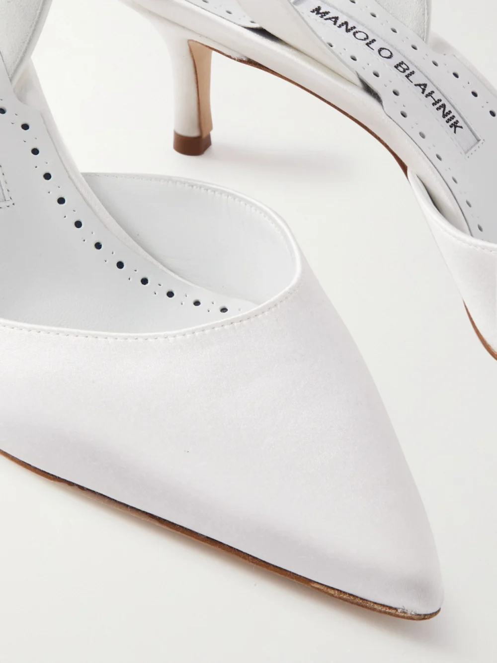 Close-up detail of the Manolo Blahnik Carolyne Bridal 50 Satin Slingback Pumps