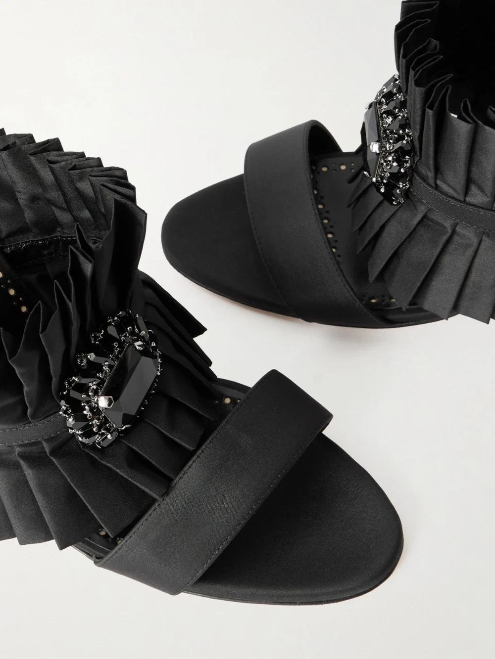 Close-up detail of the Manolo Blahnik Danteuil 90 Embellished Pleated Silk Mules