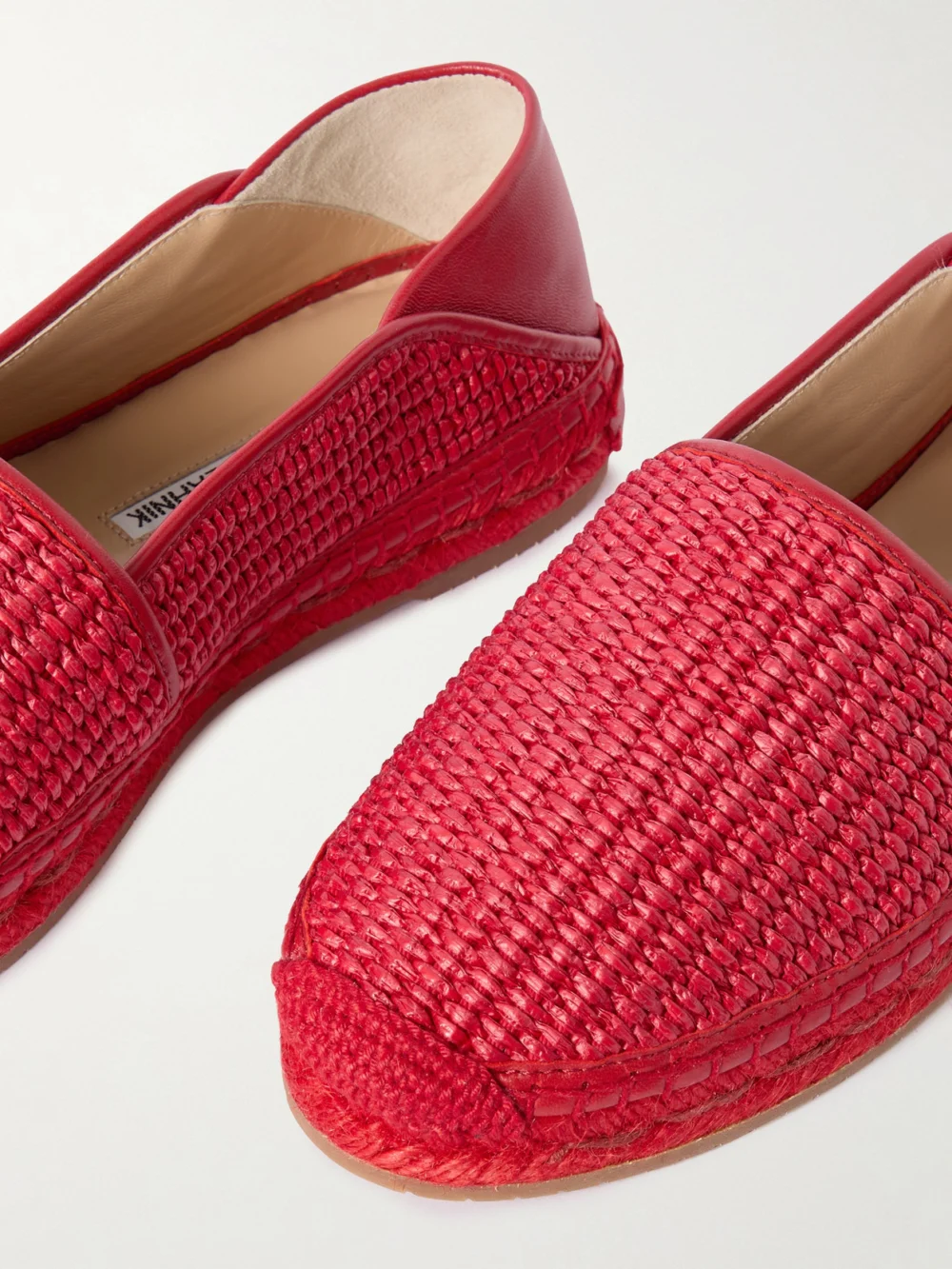 Close-up detail of the Manolo Blahnik Espadra Collapsible-heel Leather-trimmed Raffia Espadrilles