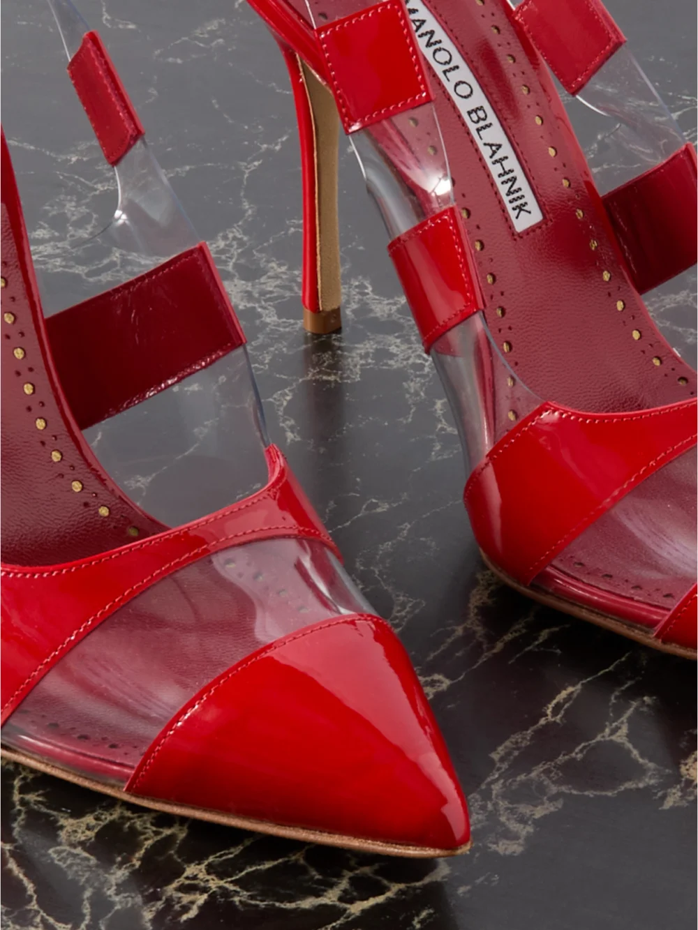 Close-up detail of the Manolo Blahnik Uxra 105 Patent-leather and Pvc Slingback Pumps