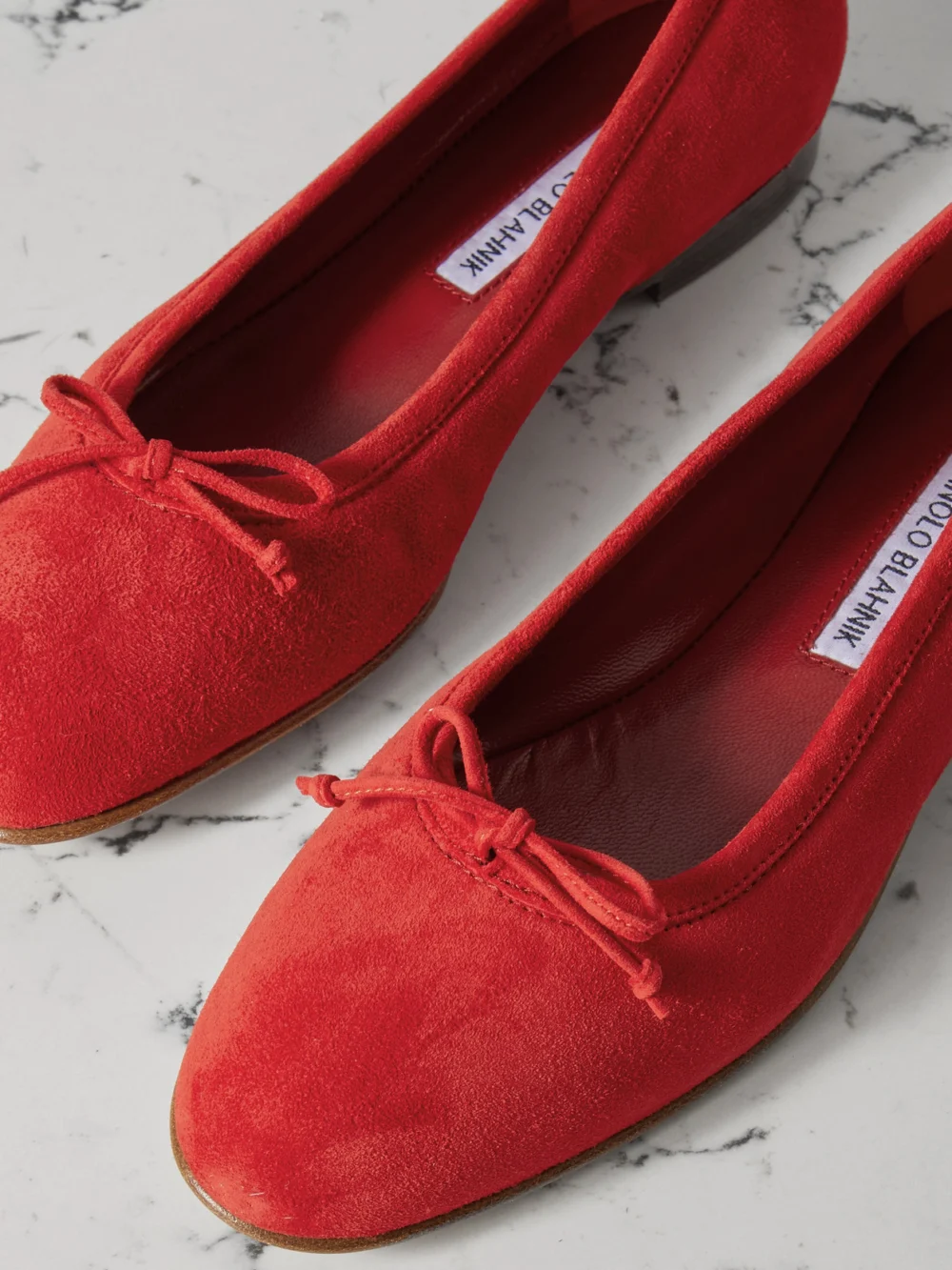 Close-up detail of the Manolo Blahnik Veralli Bow-detailed Suede Ballet Flats