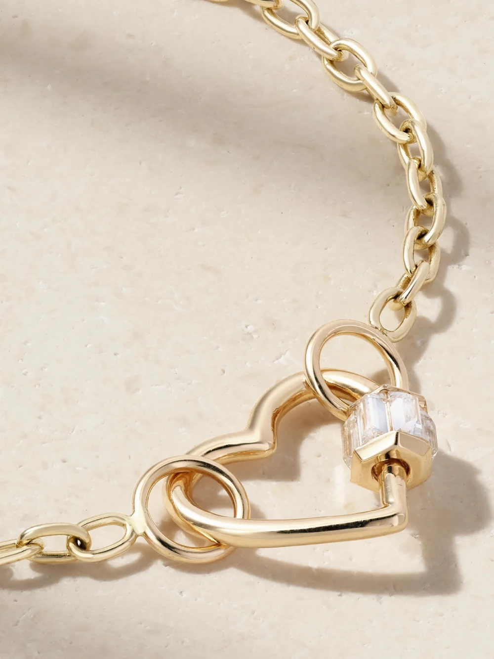 Close-up detail of the Marla Aaron Baguette Baby Heart Lock + Pulley Chain 14-karat Gold Diamond Bracelet