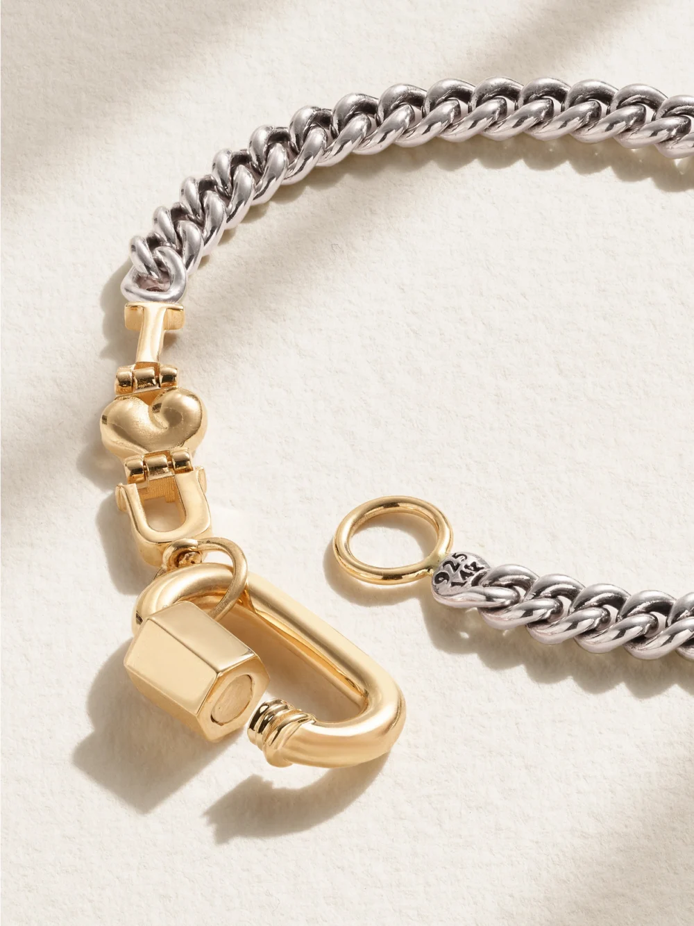 Close-up detail of the Marla Aaron Curb Talking + Chubby Babylock Silver and 14-karat Yellow Gold Bracelet