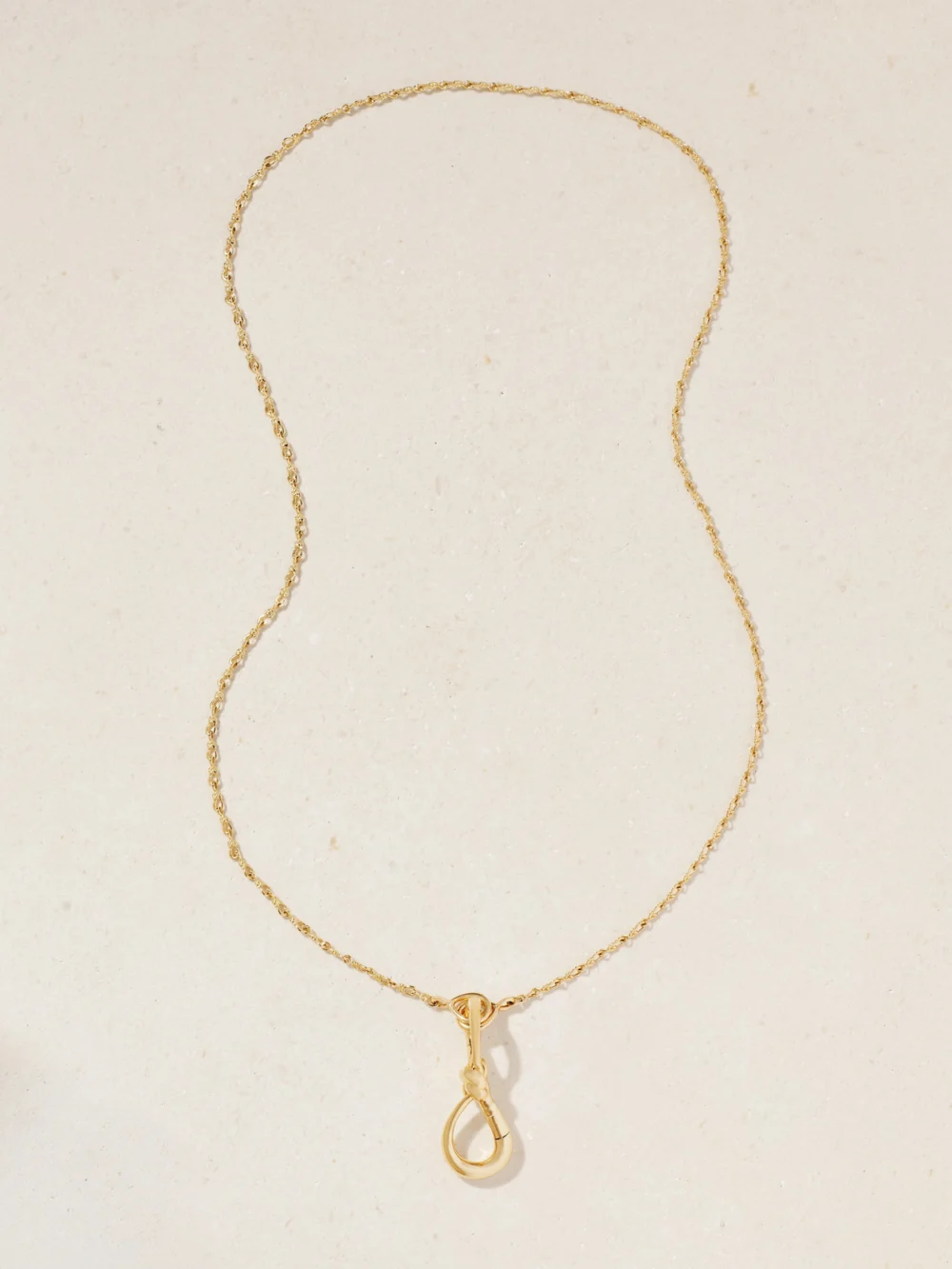 Close-up detail of the Marla Aaron Small True Lover's Knot Lock + Chain 18-karat Gold Necklace