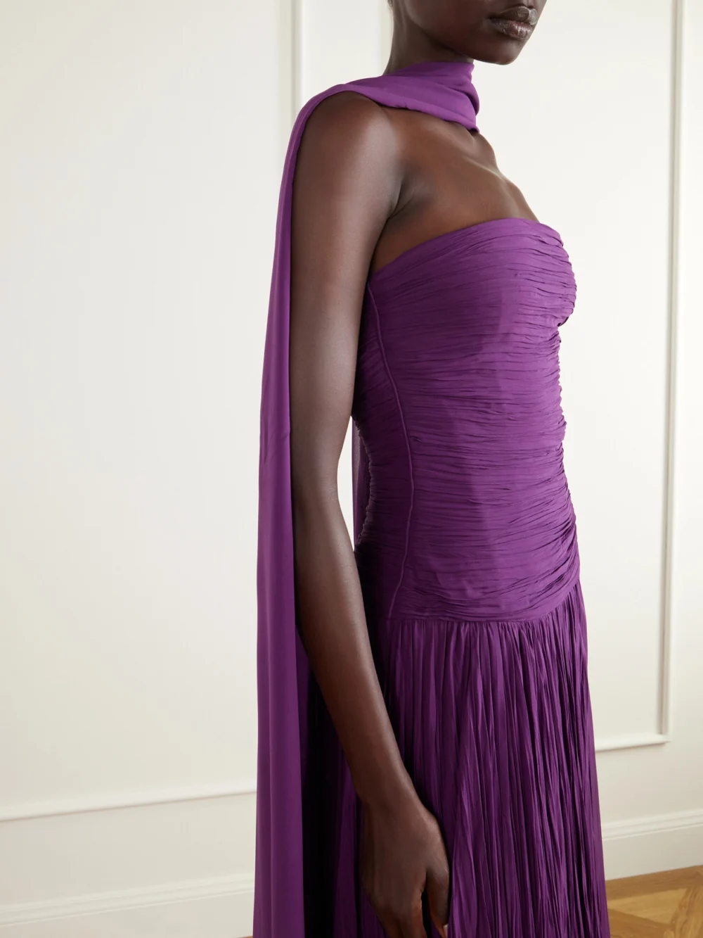 Close-up detail of the Marmar Halim Cape-effect Strapless Ruched Plissé Crepe Bustier Gown