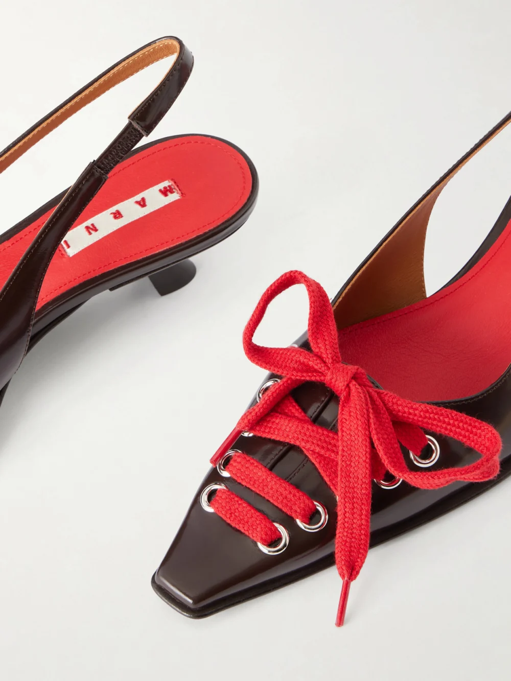 Close-up detail of the Marni Kat Lace-up Leather Slingback Pumps