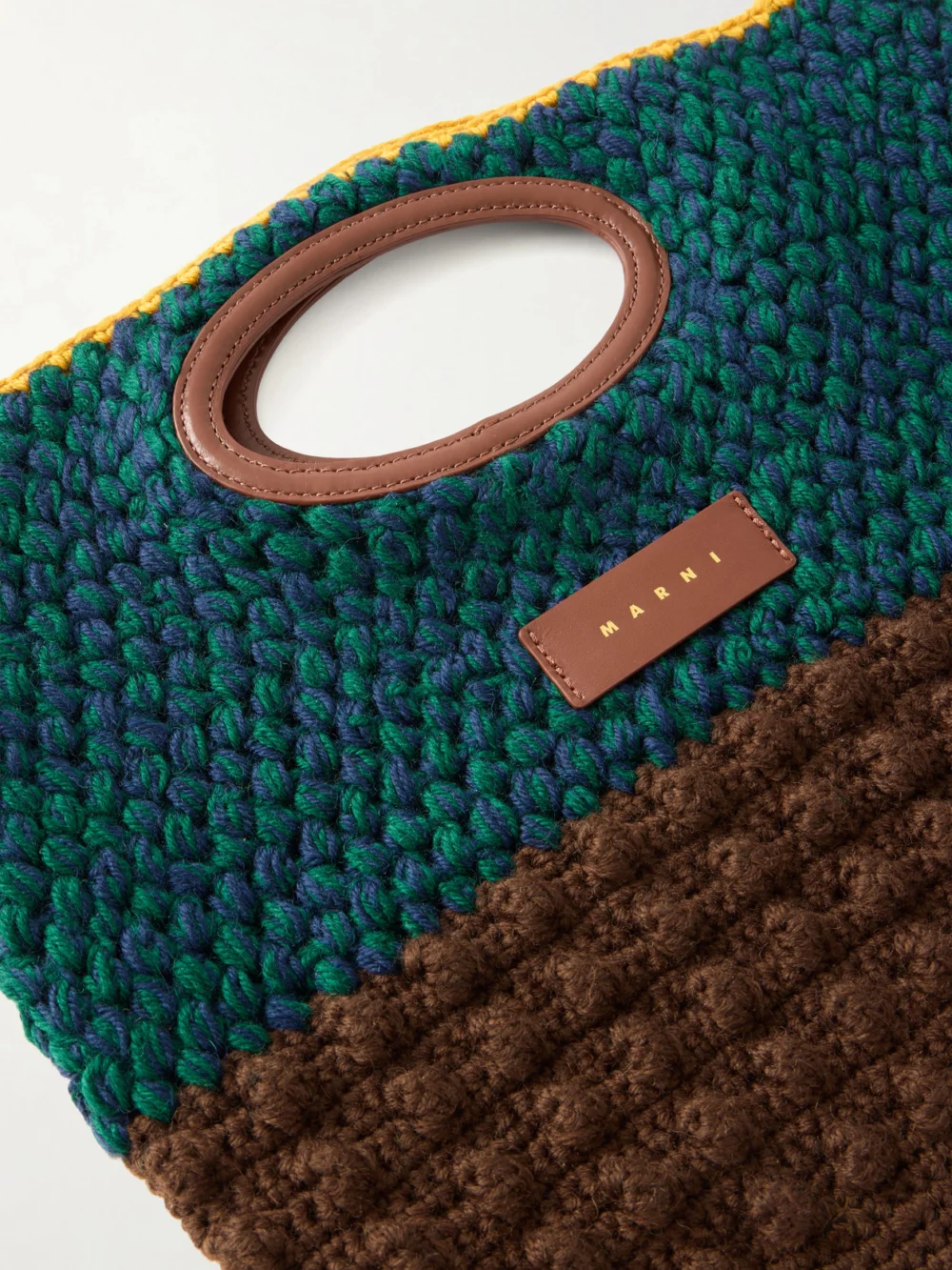 Close-up detail of the Marni Logo-appliquéd Leather-trimmed Knitted Wool Clutch