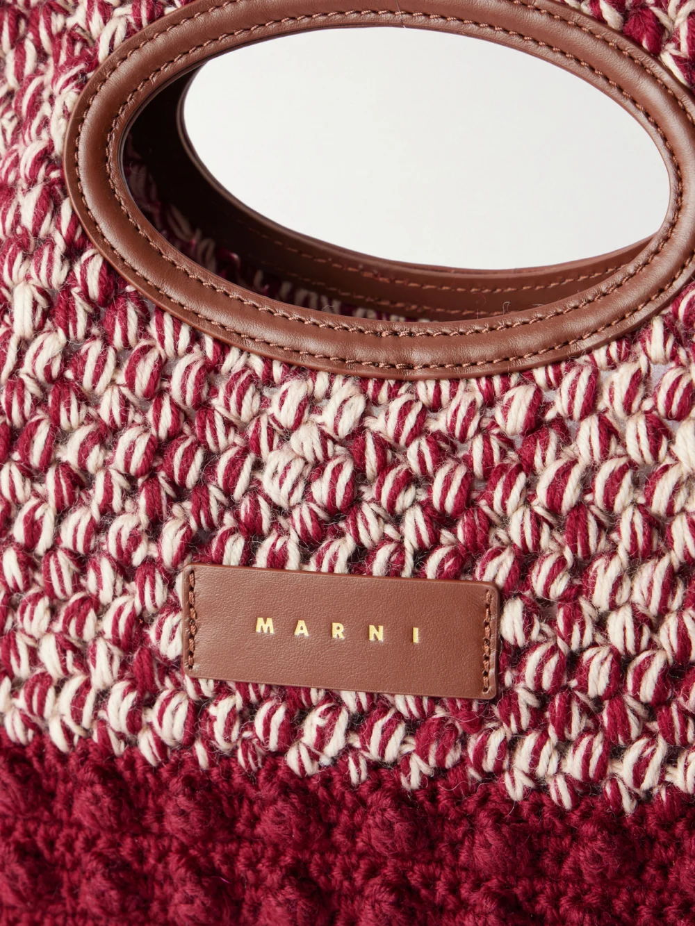 Close-up detail of the Marni Logo-appliquéd Leather-trimmed Knitted Wool Clutch