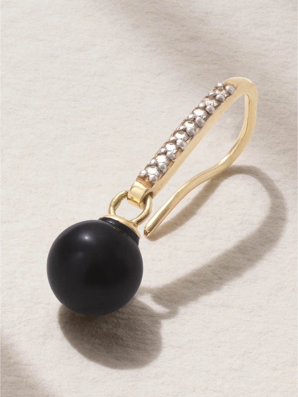 Close-up detail of the Mateo 14-karat Gold, Onyx and Diamond Earrings