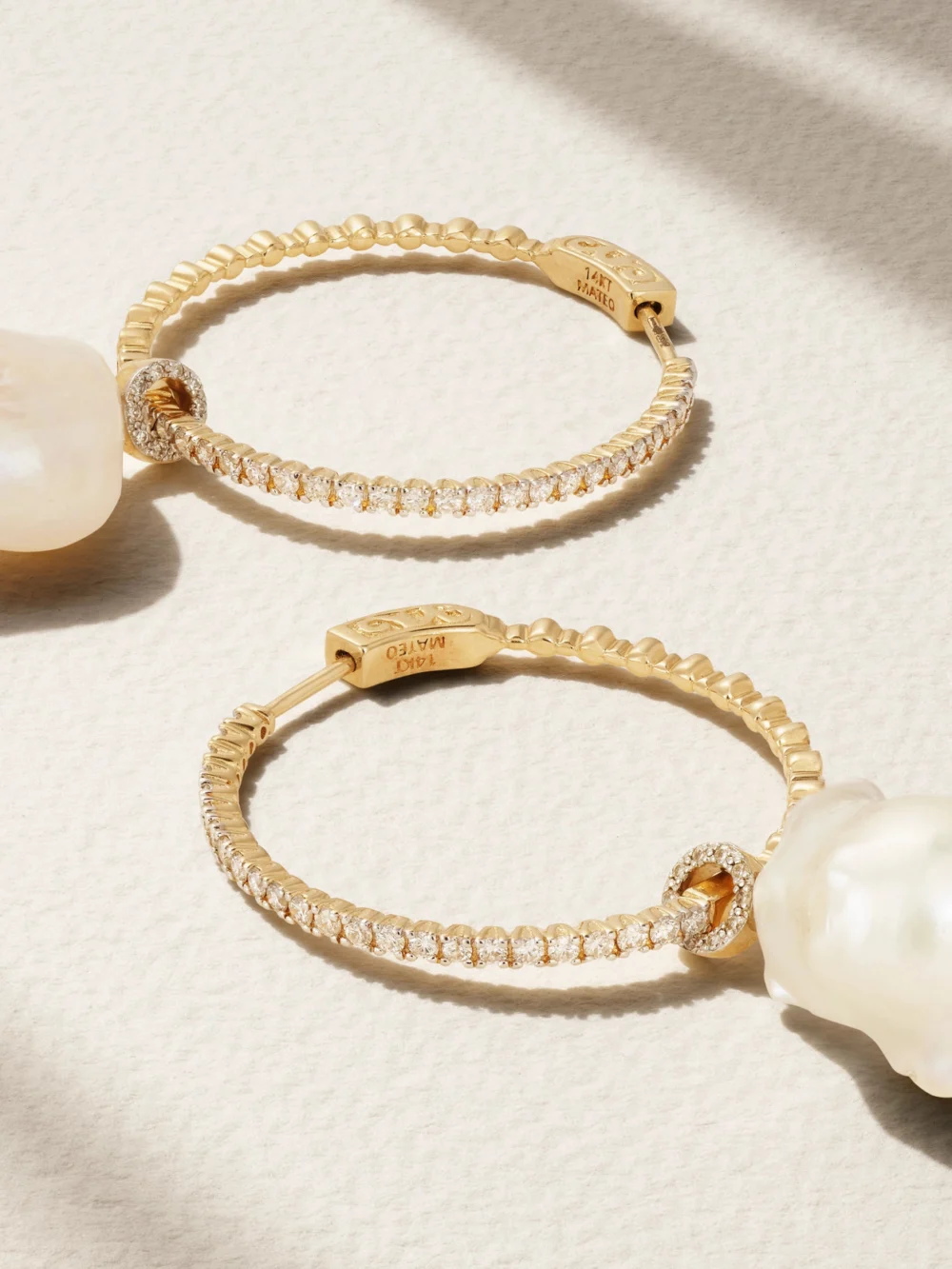 Close-up detail of the Mateo 14-karat Gold, Pearl and Diamond Hoop Earrings
