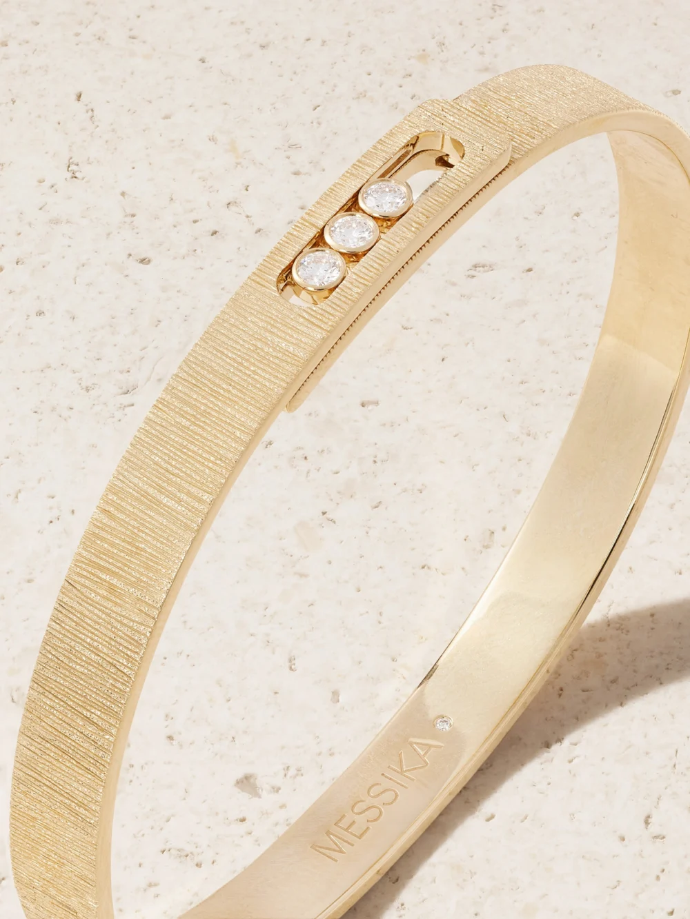 Close-up detail of the Messika Move Noa Ciselé 14-karat Gold Diamond Bangle