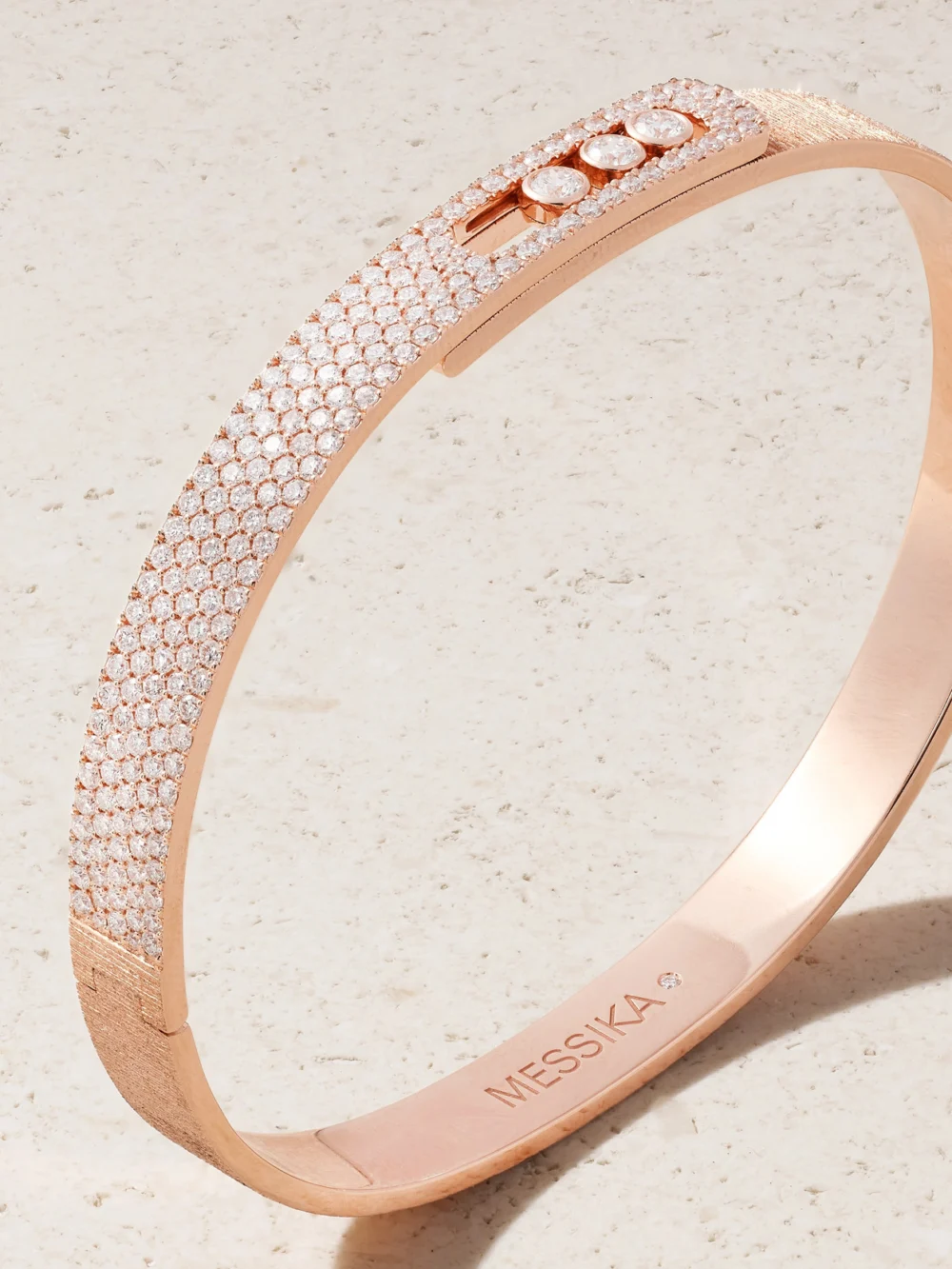 Close-up detail of the Messika Move Noa Ciselé 18-karat Rose Gold Diamond Bangle