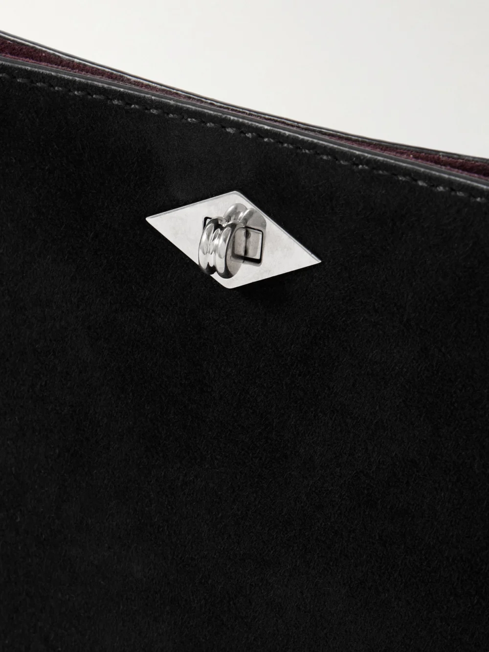 Close-up detail of the Métier Ease Suede Clutch