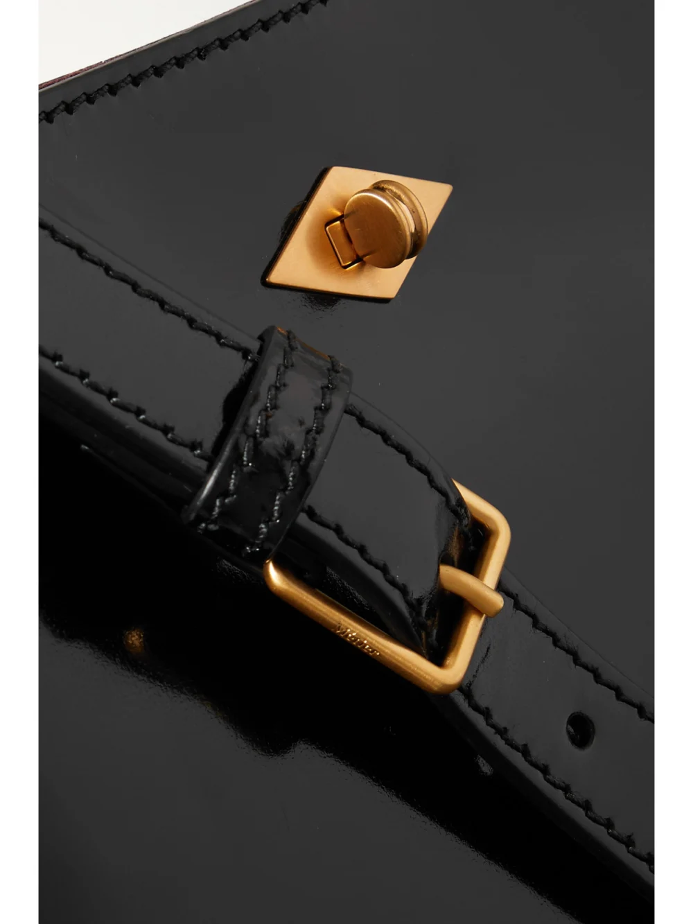 Close-up detail of the Métier Stowaway Glossed-leather Shoulder Bag
