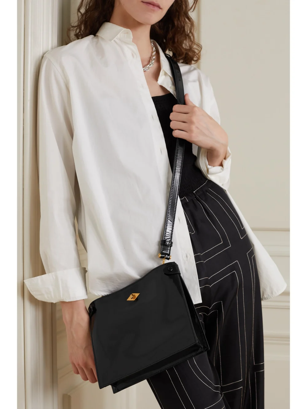 Métier Stowaway Glossed-leather Shoulder Bag, styled view
