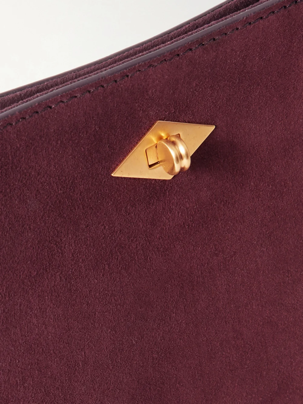 Close-up detail of the Métier Stowaway Suede Shoulder Bag