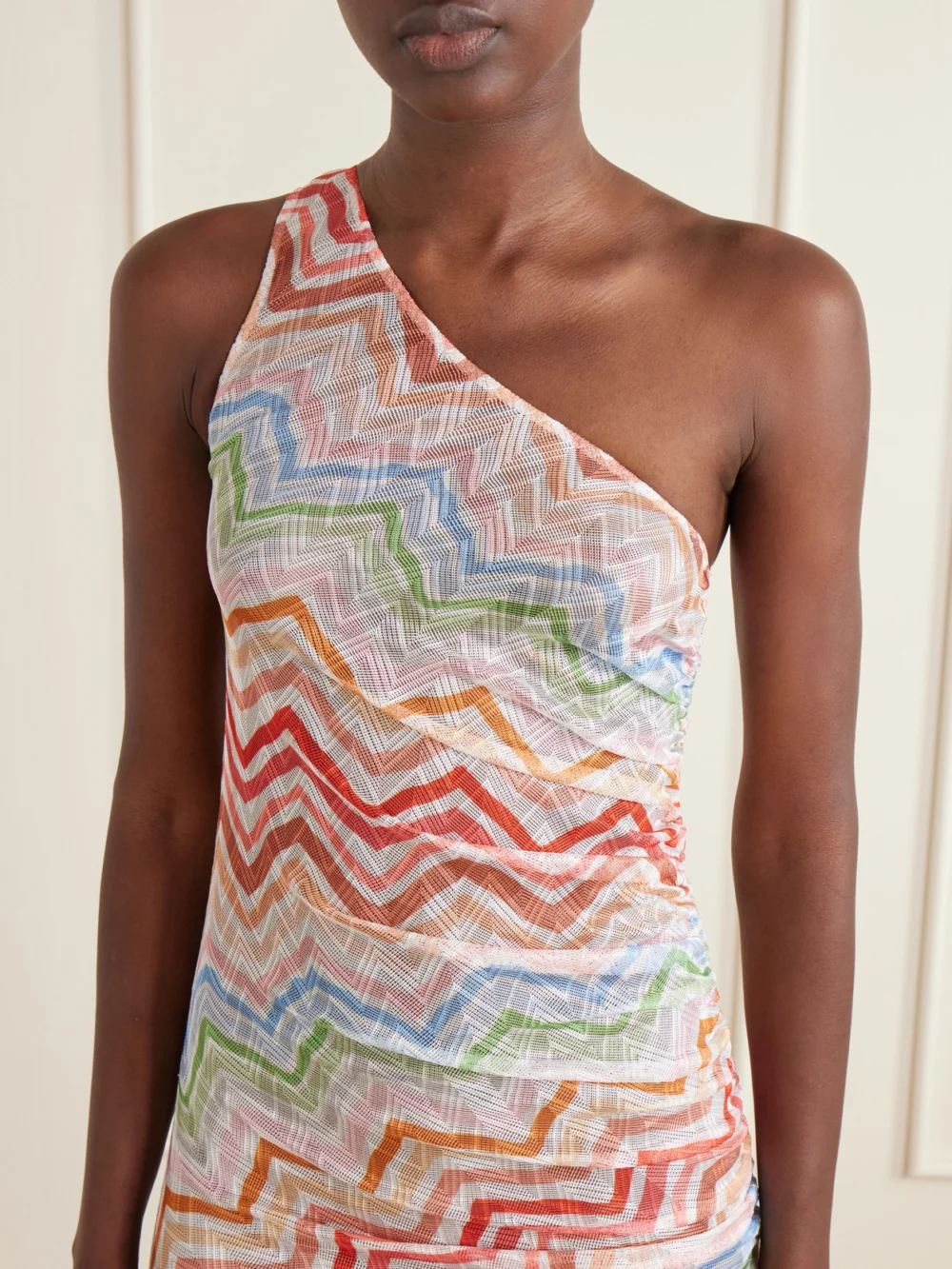 Close-up detail of the Missoni One-shoulder Fringed Striped Crochet-knit Mini Dress