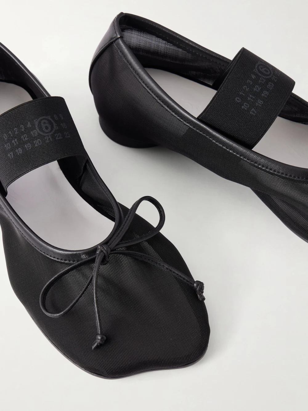 Close-up detail of the MM6 Maison Margiela Bow-detailed Leather-trimmed Mesh Ballet Flats