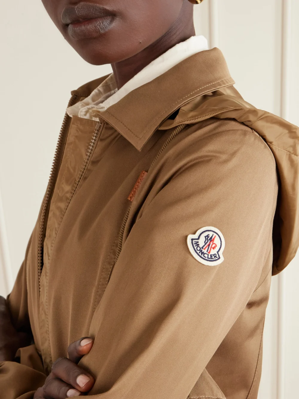 Close-up detail of the Moncler Adenium Cropped Hooded Shell-paneled Gabardine Jacket