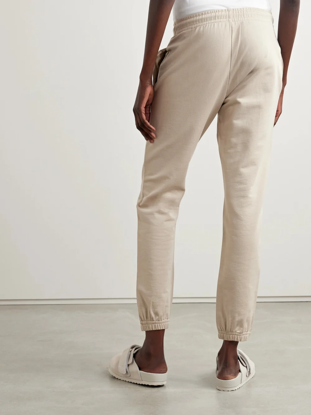 Back view of the Moncler Appliquéd Cotton-jersey Tapered Track Pants