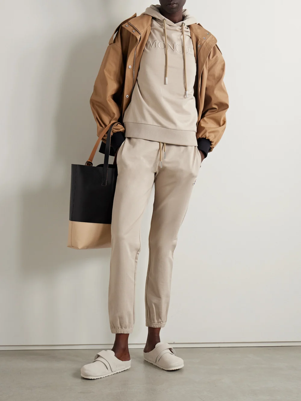 Moncler Appliquéd Cotton-jersey Tapered Track Pants, worn by a model