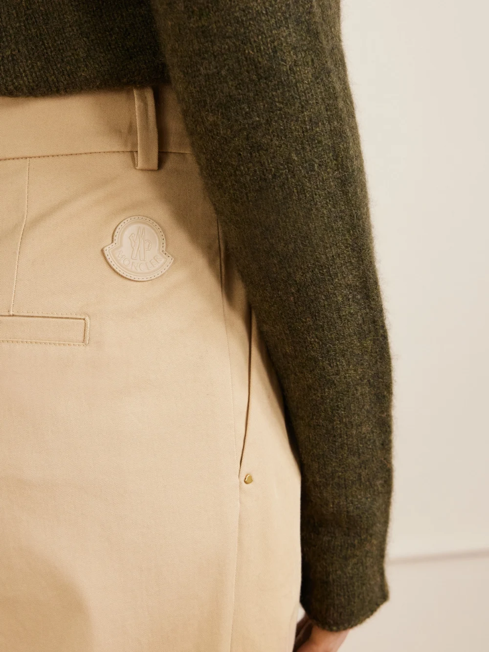 Close-up detail of the Moncler Appliquéd Pleated Cotton-twill Wide-leg Pants