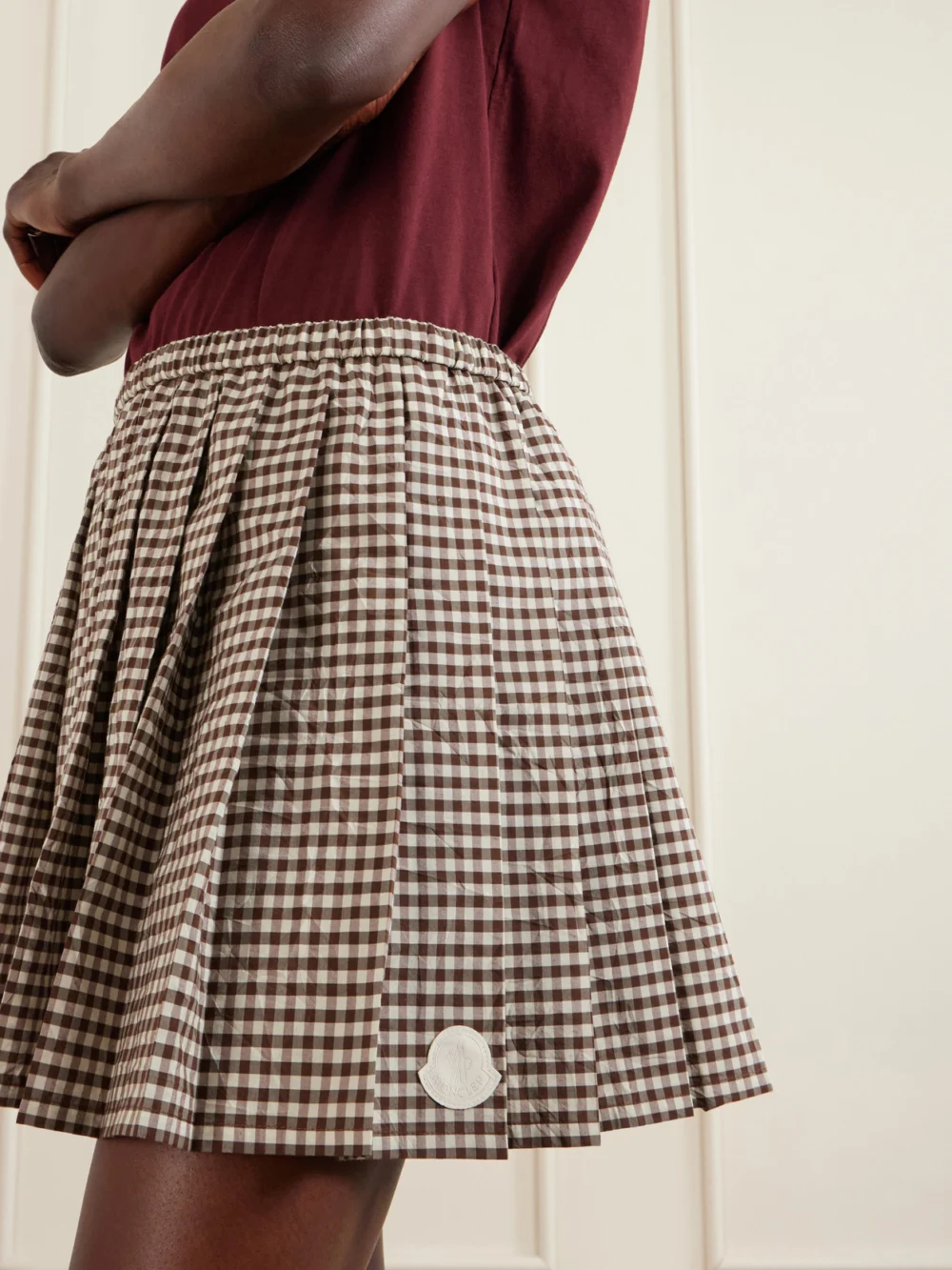 Close-up detail of the Moncler Appliquéd Pleated Gingham Cotton-blend Mini Skirt