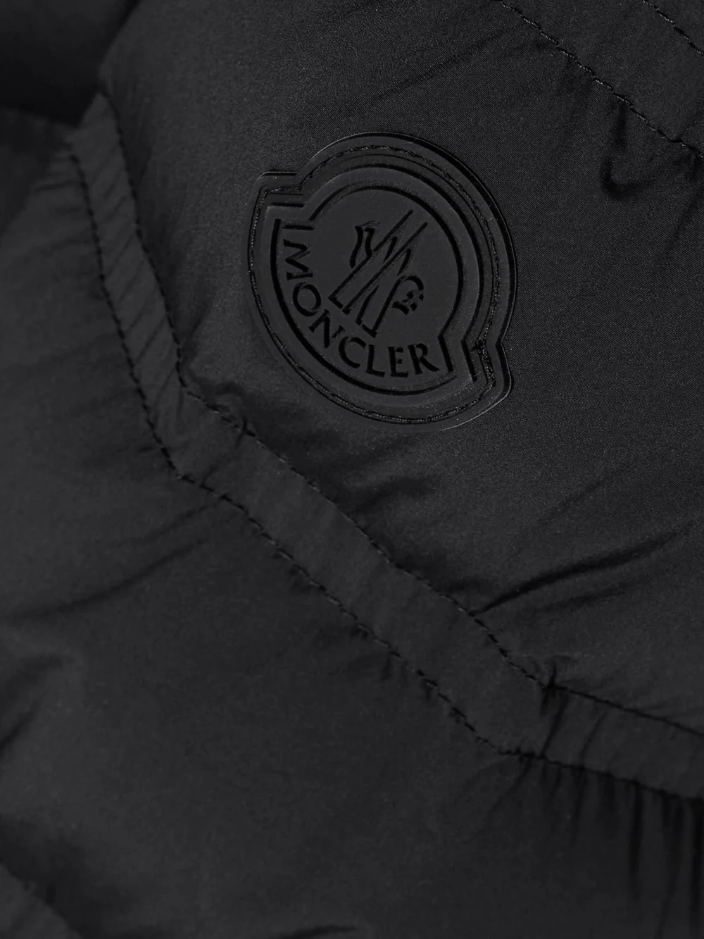 Close-up detail of the Moncler Appliquéd Webbing-trimmed Quilted Shell Down Jacket
