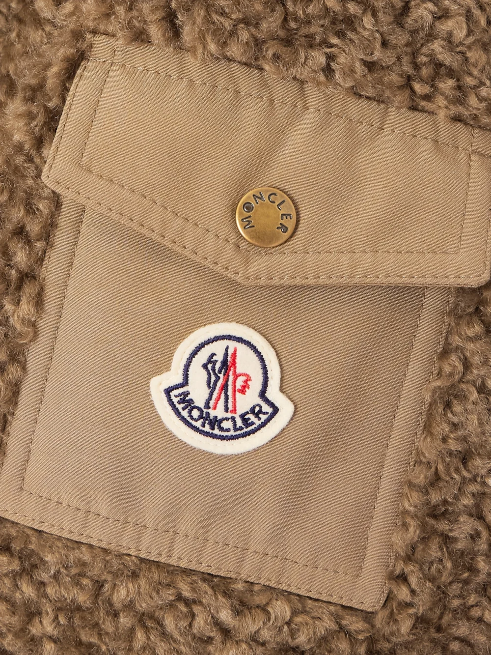 Close-up detail of the Moncler Coligny Shell-trimmed Fleece Down Jacket