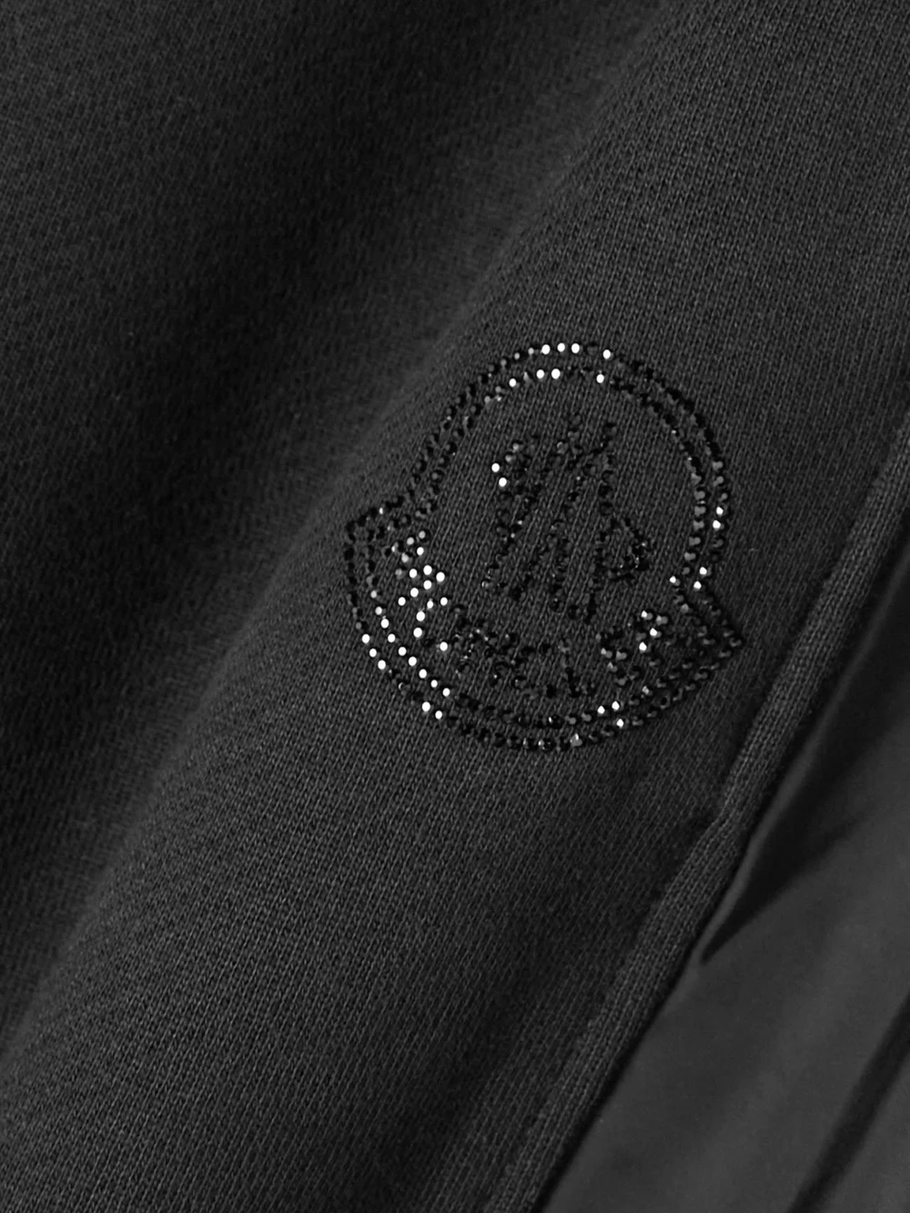 Close-up detail of the Moncler Embellished Shell-trimmed Cotton-jersey Track Pants