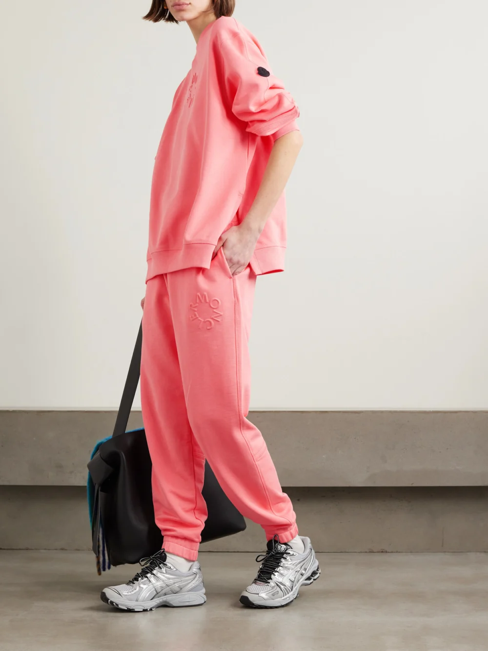Moncler Embossed Cotton-jersey Tapered Track Pants, worn by a model