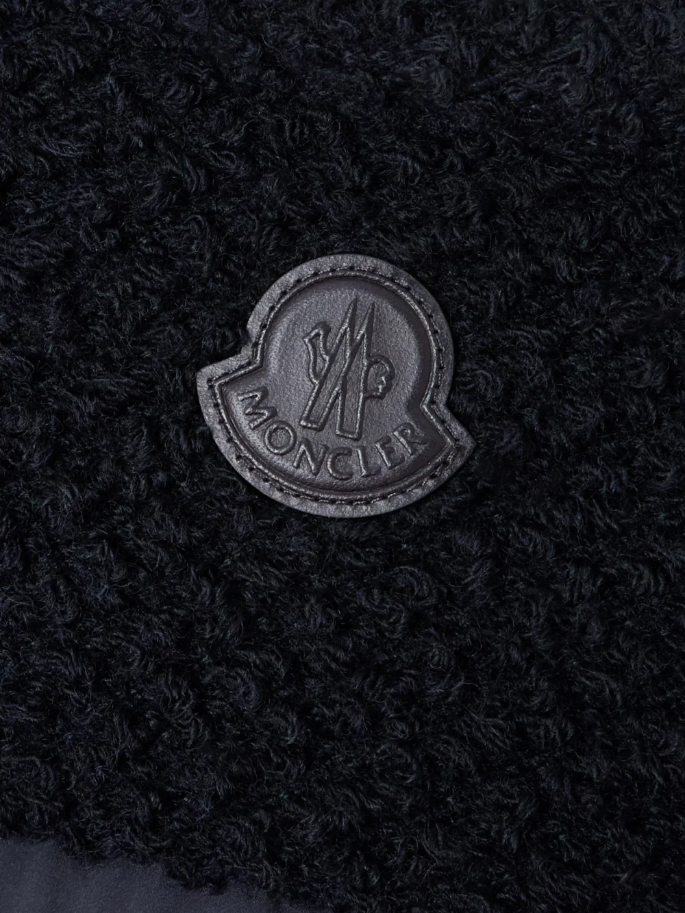 Close-up detail of the Moncler Fallavier Appliquéd Quilted Shell and Wool-bouclé Down Vest