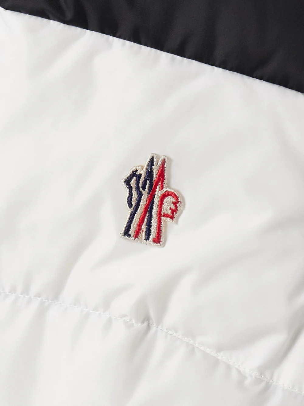Close-up detail of the Moncler Grenoble Belted Paneled Quilted Down Ski Suit