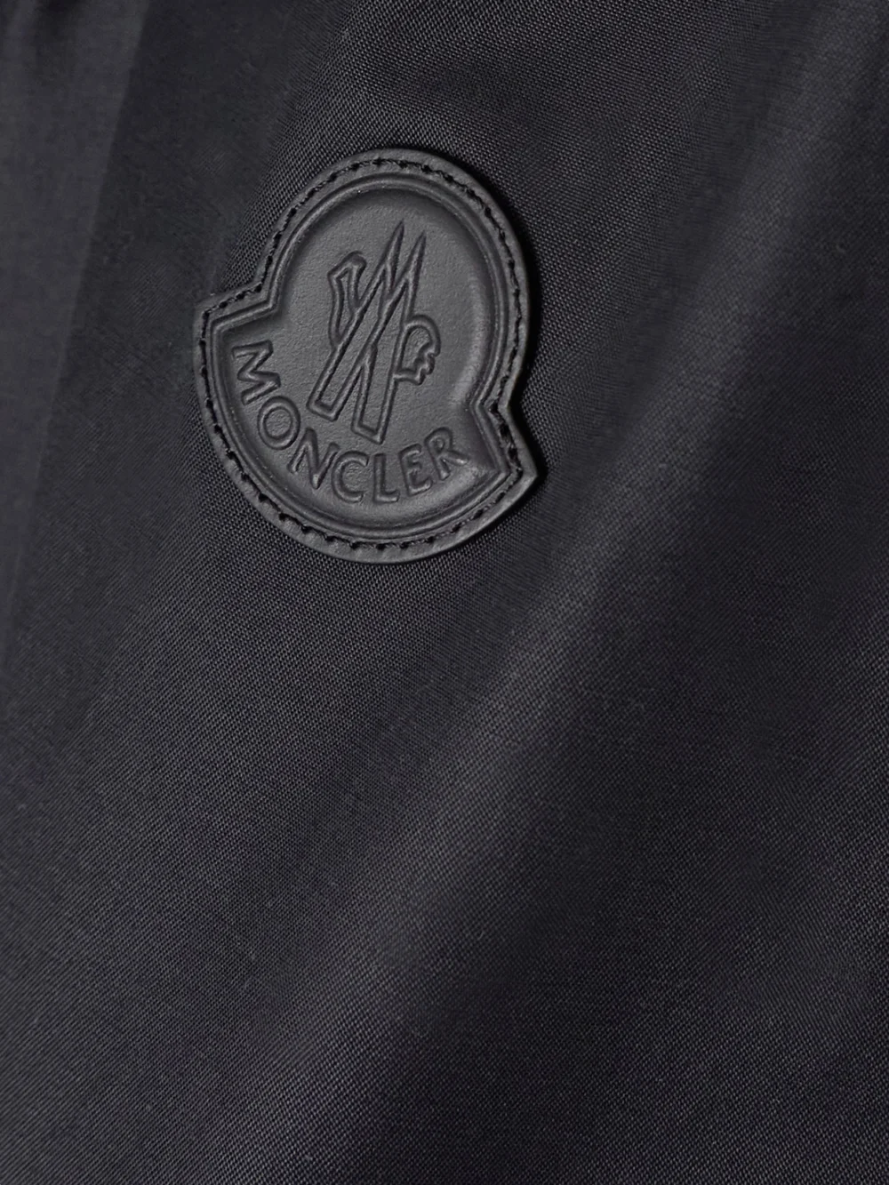 Close-up detail of the Moncler Gruissan Appliquéd Cotton-blend Bomber Jacket