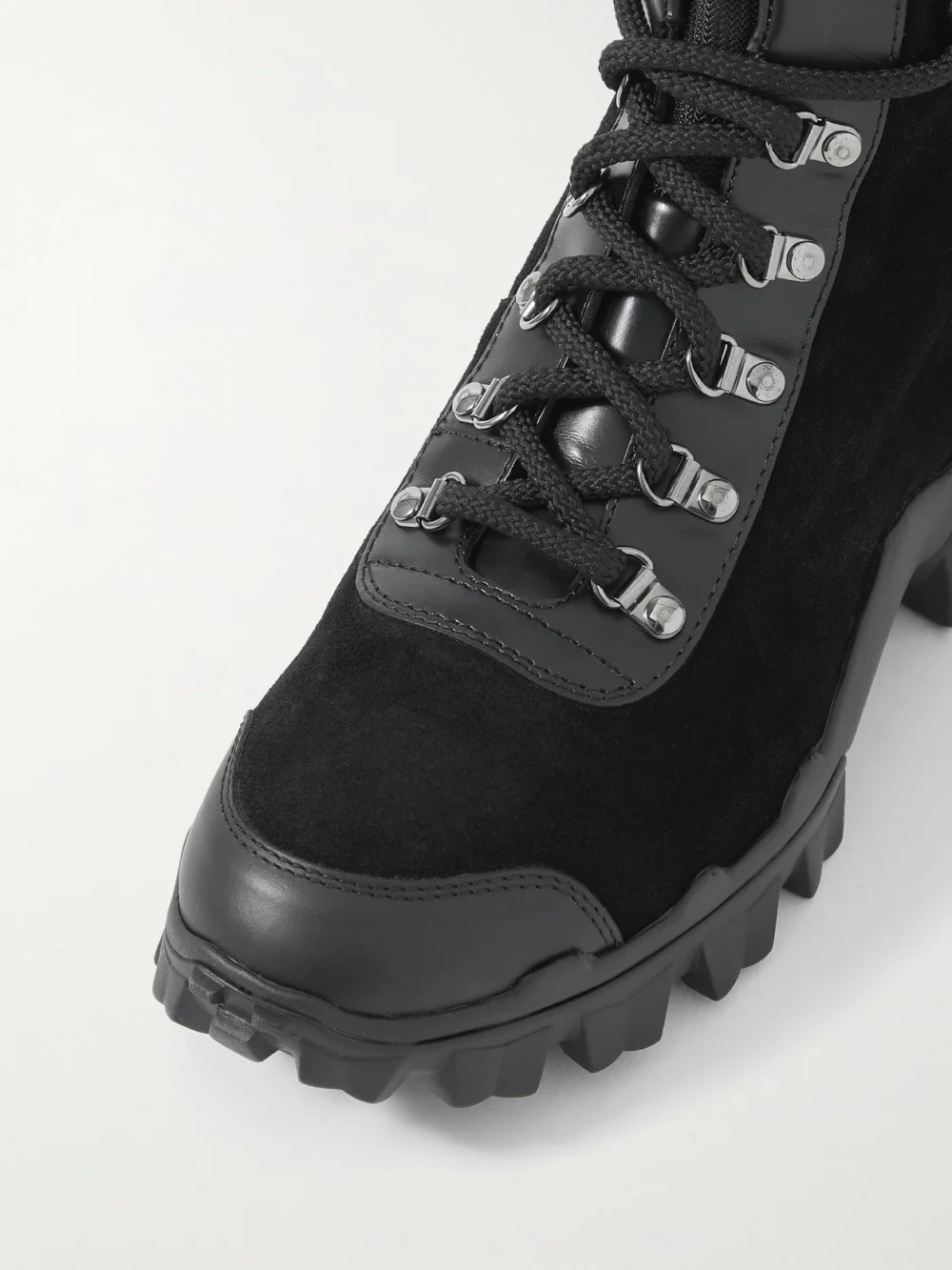 Close-up detail of the Moncler Helis Logo-print Leather-trimmed Suede Ankle Boots