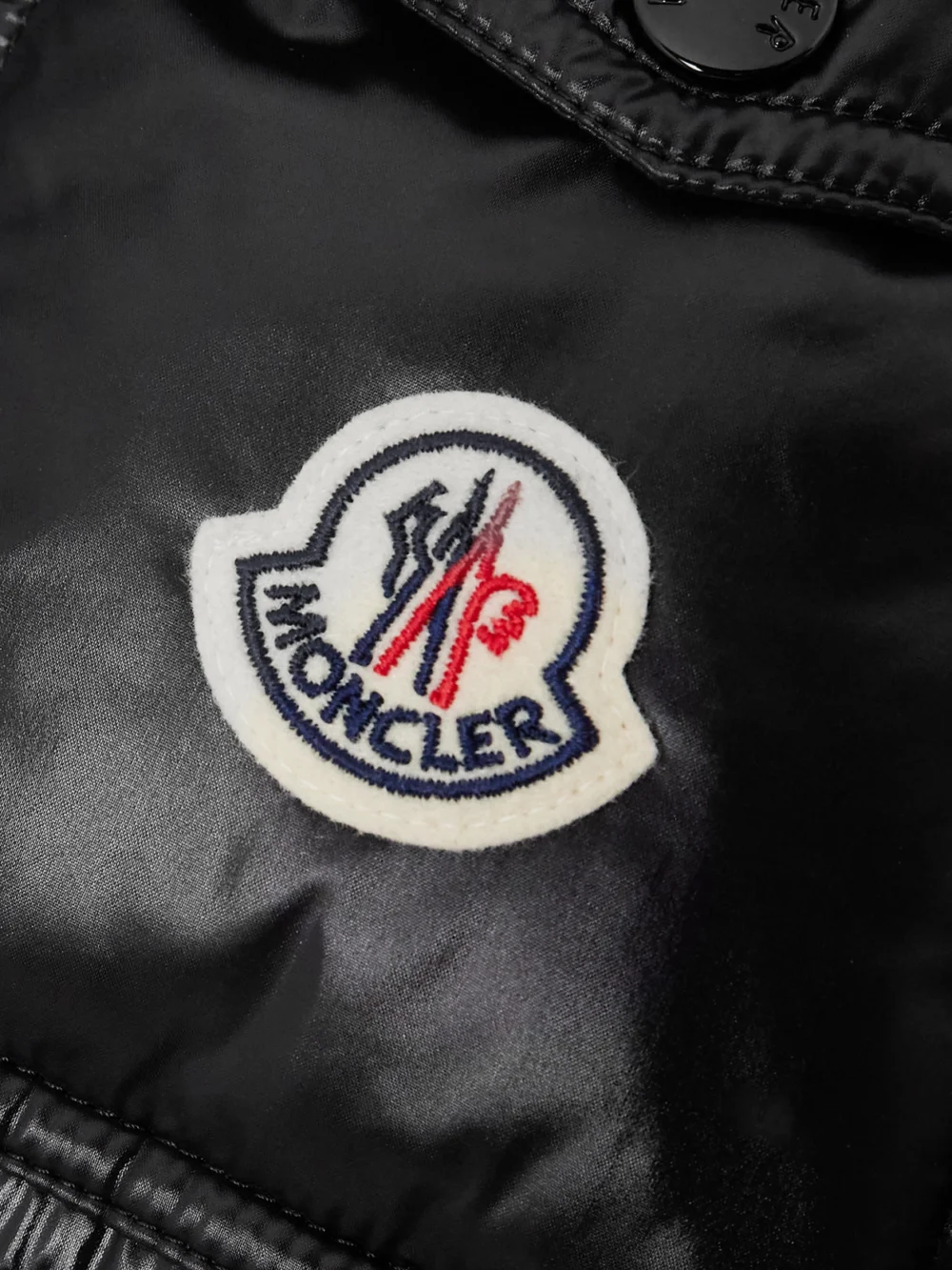 Close-up detail of the Moncler Maire Hooded Quilted Glossed-shell Down Jacket