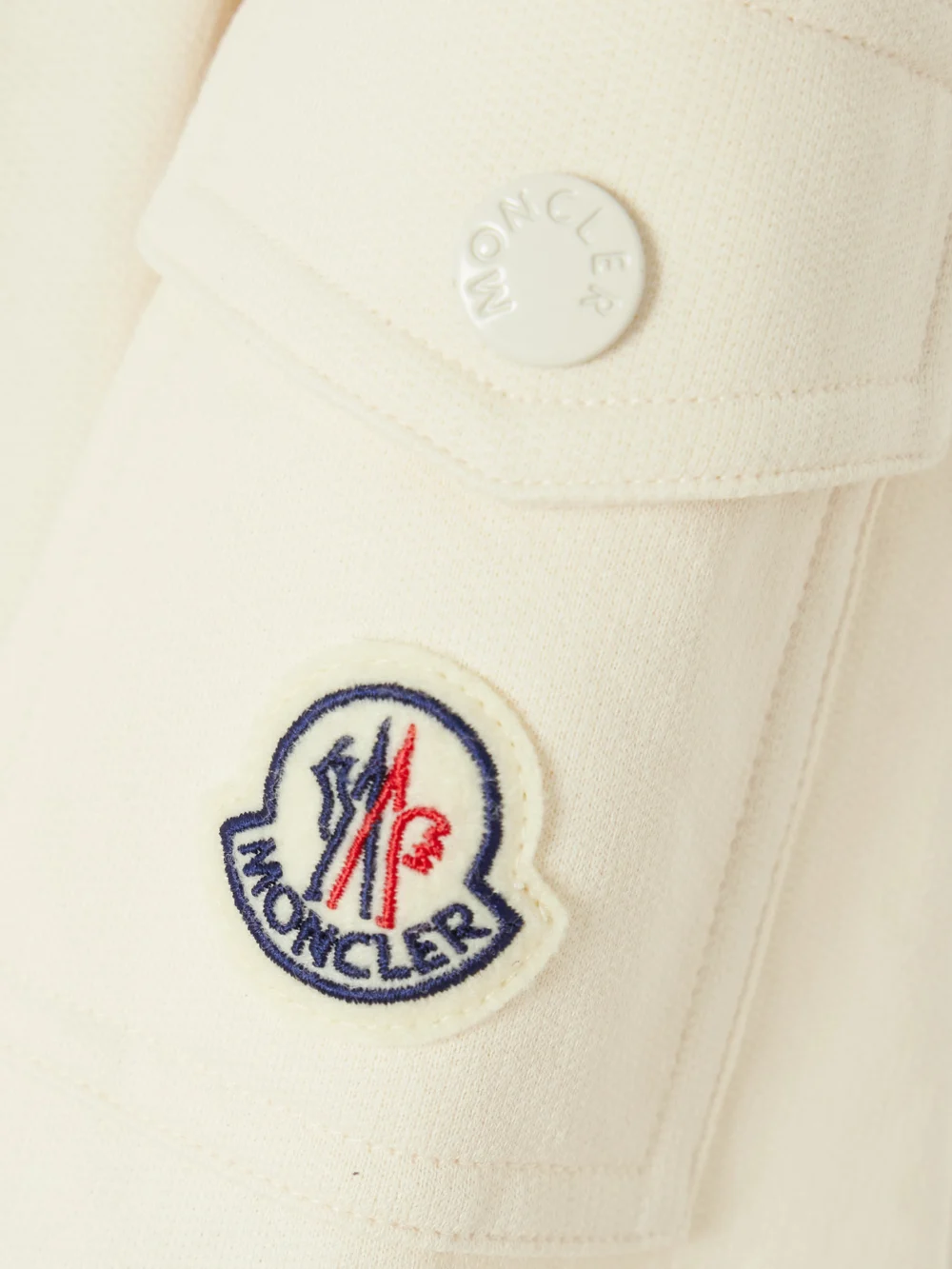 Close-up detail of the Moncler Pleated Cotton-piqué Mini Shirt Dress