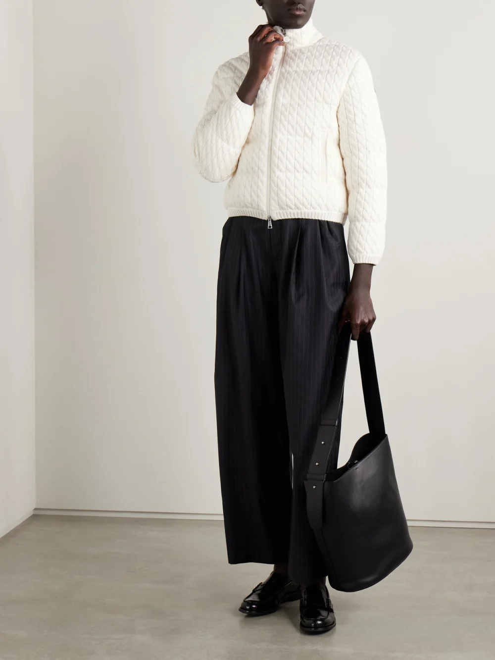 Moncler Quilted Padded Cable-knit Cotton-blend Down Jacket, worn by a model