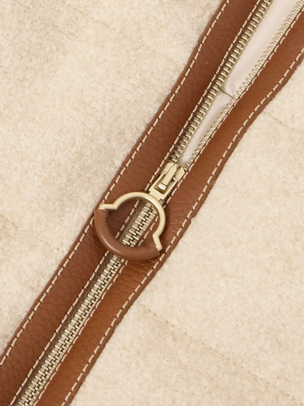 Close-up detail of the Moncler Serinde Leather-trimmed Quilted Wool-blend Bouclé Down Jacket