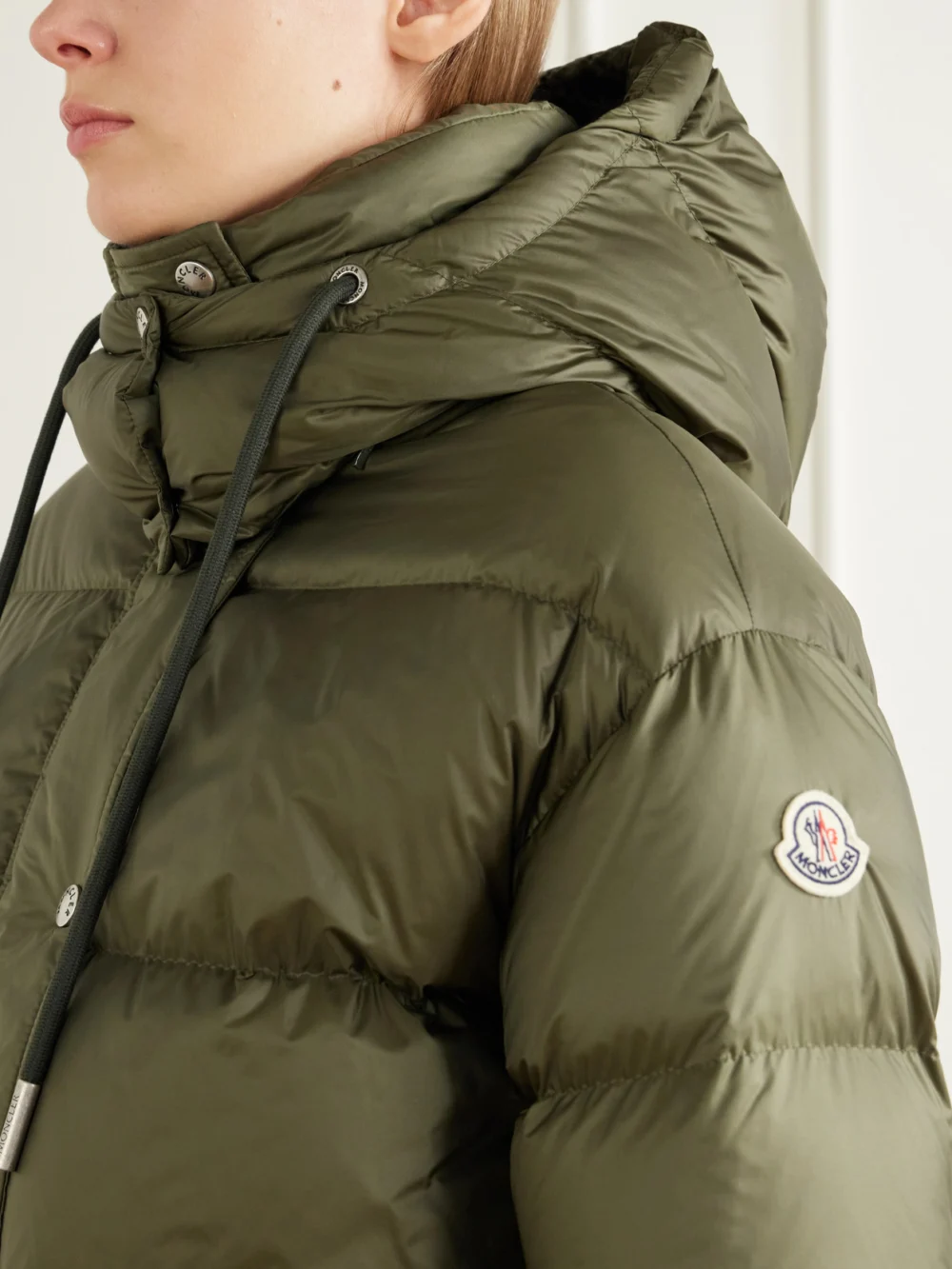 Close-up detail of the Moncler Sesie Hooded Quilted Shell Down Jacket