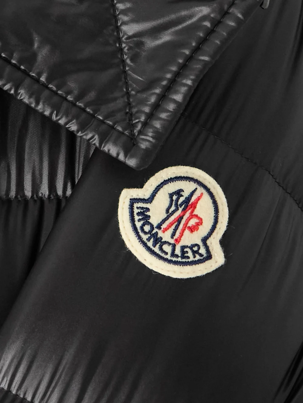 Close-up detail of the Moncler Suyen Appliquéd Quilted Shell Down Hooded Parka