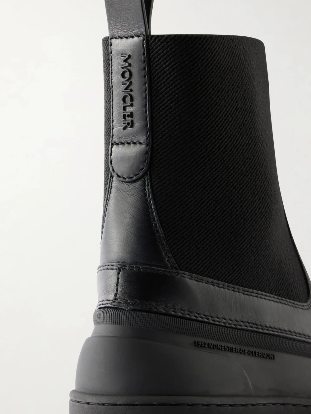 Close-up detail of the Moncler Vera Edge Rubber-trimmed Leather Ankle Boots