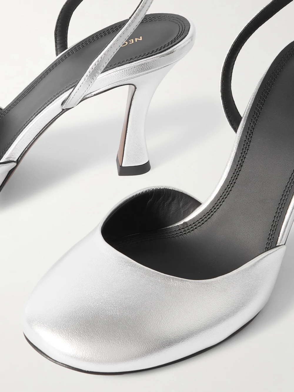 Close-up detail of the Neous Baten Metallic Leather Slingback Pumps