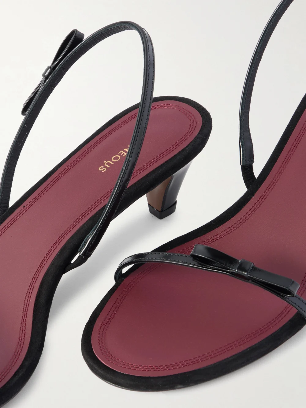 Close-up detail of the Neous Diwo Bow-embellished Patent-leather Slingback Sandals