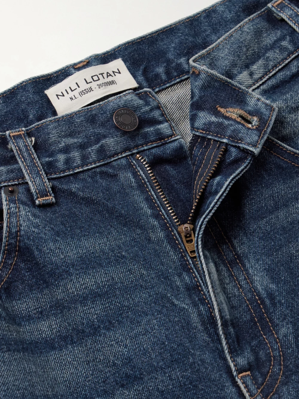 Close-up detail of the Nili Lotan Calla Distressed Mid-rise Straight-leg Jeans