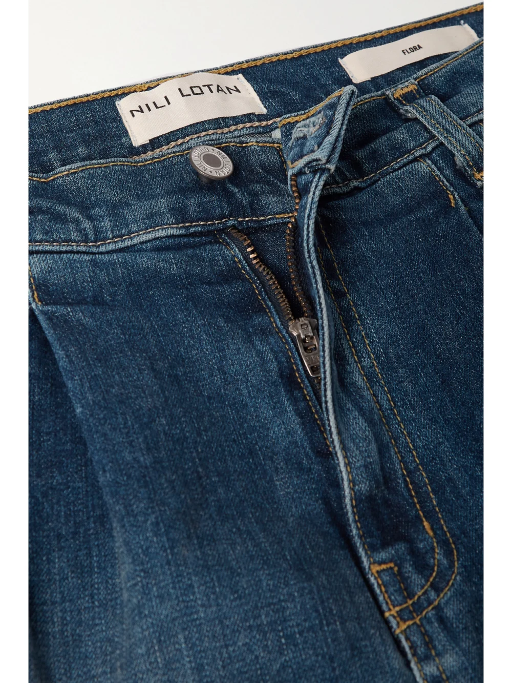 Close-up detail of the Nili Lotan Flora Pleated High-rise Wide-leg Jeans